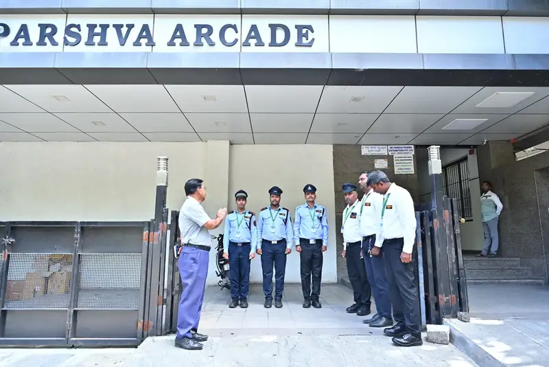 Poorvika FMS guards on duty at a commercial arcade entrance